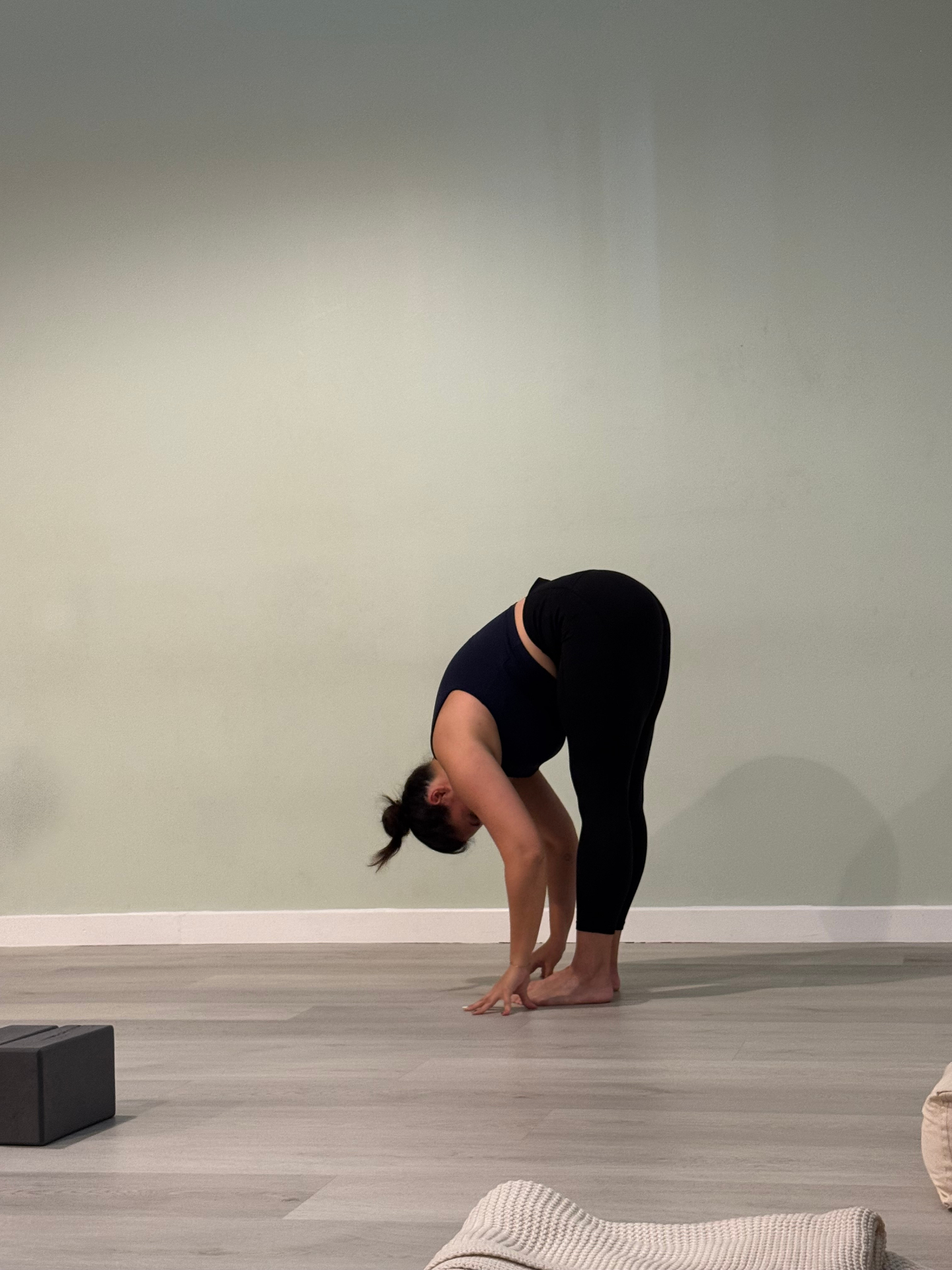Yoga forward fold in a peaceful studio