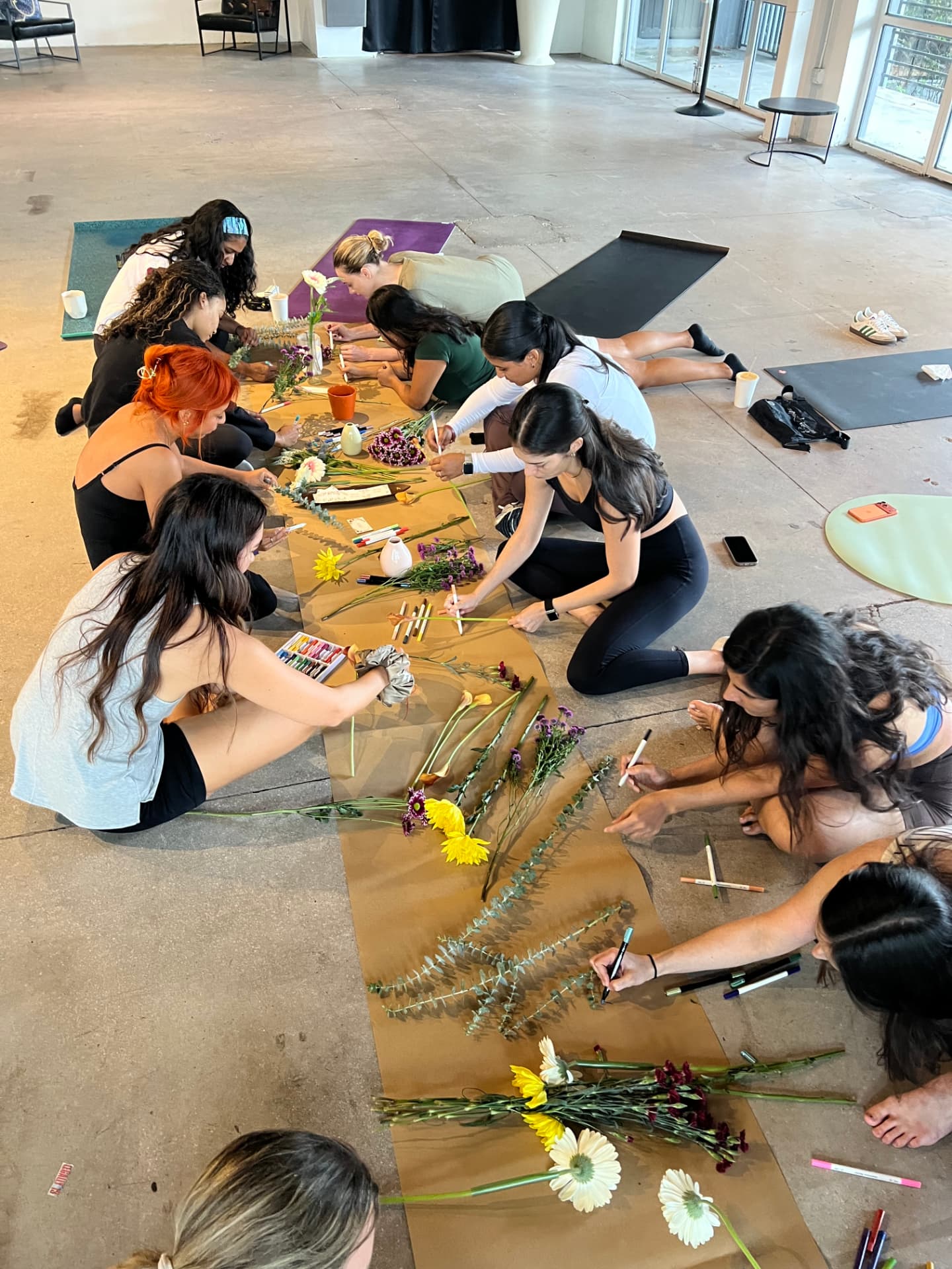 Community creating art with flowers